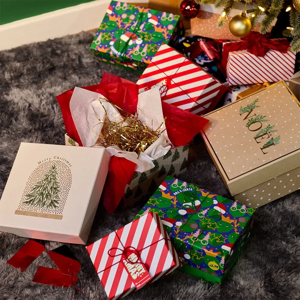 Christmas gift boxes and wrapped presents arranged beneath a decorated Christmas tree with festive packaging and seasonal decorations. Christmas gift boxes and wrapped presents arranged beneath a decorated Christmas tree with festive packaging and seasonal decorations.